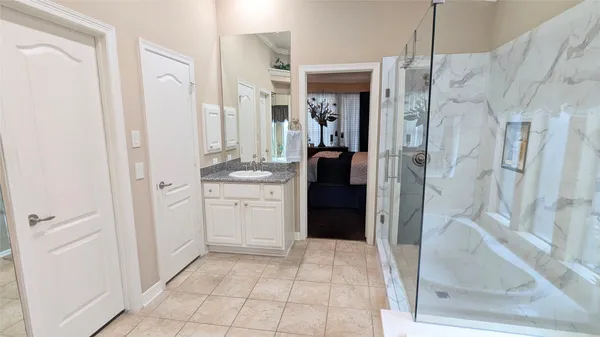 a bathroom with a granite countertop sink and a mirror