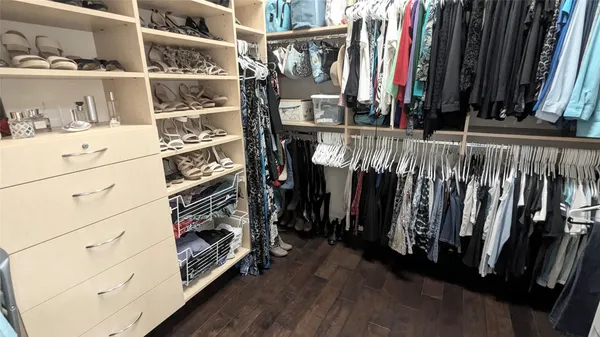 a view of walk in closet with clothes