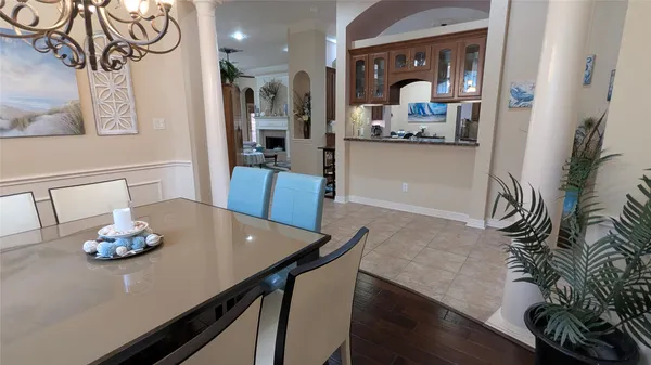 a dining room with furniture and wooden floor