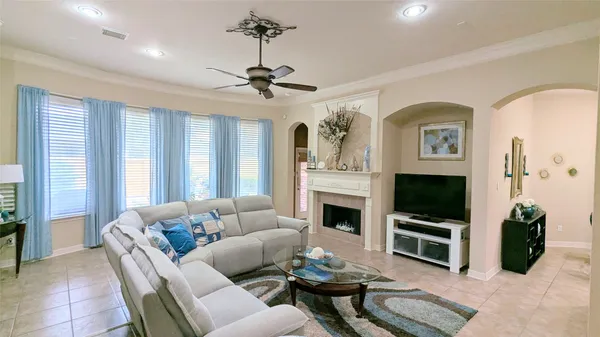 a living room with furniture a flat screen tv and a fireplace