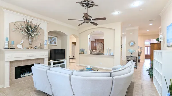 a living room with furniture a fireplace and a chandelier