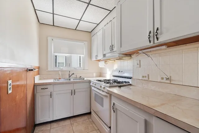 a kitchen with stainless steel appliances granite countertop a sink a stove and cabinets