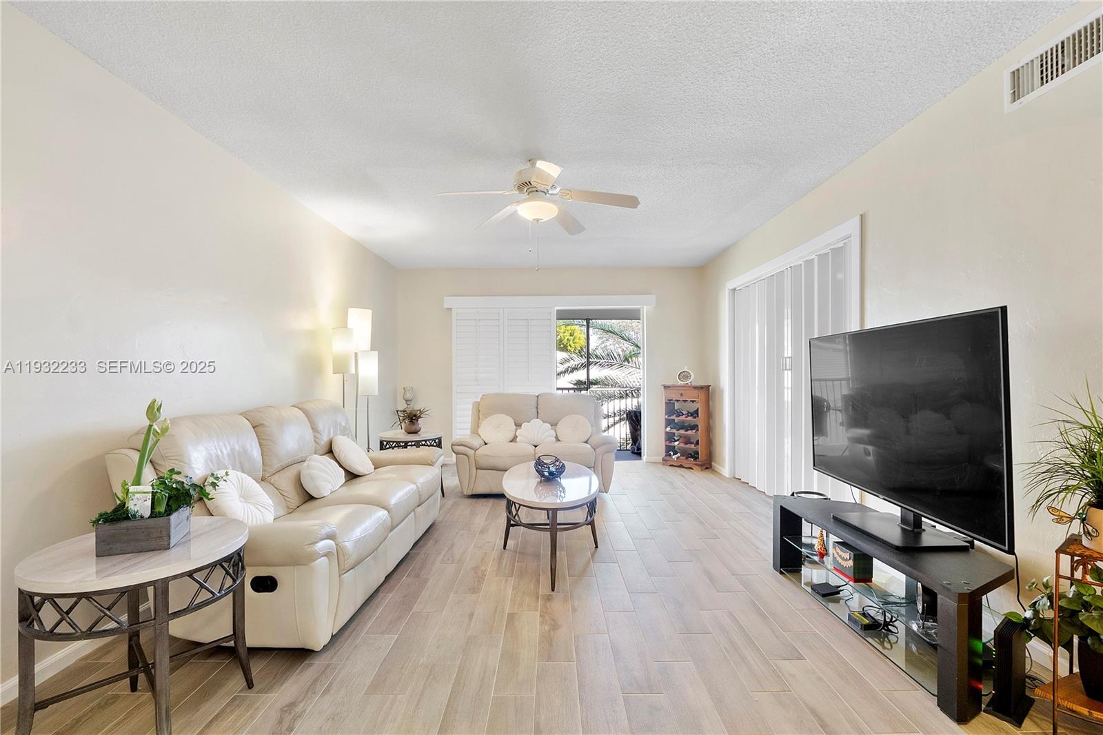 6750 Northeast 21st Road, Unit 124 Fort Lauderdale, FL 33308 - Photo 16 of 50 a living room with furniture and a flat screen tv