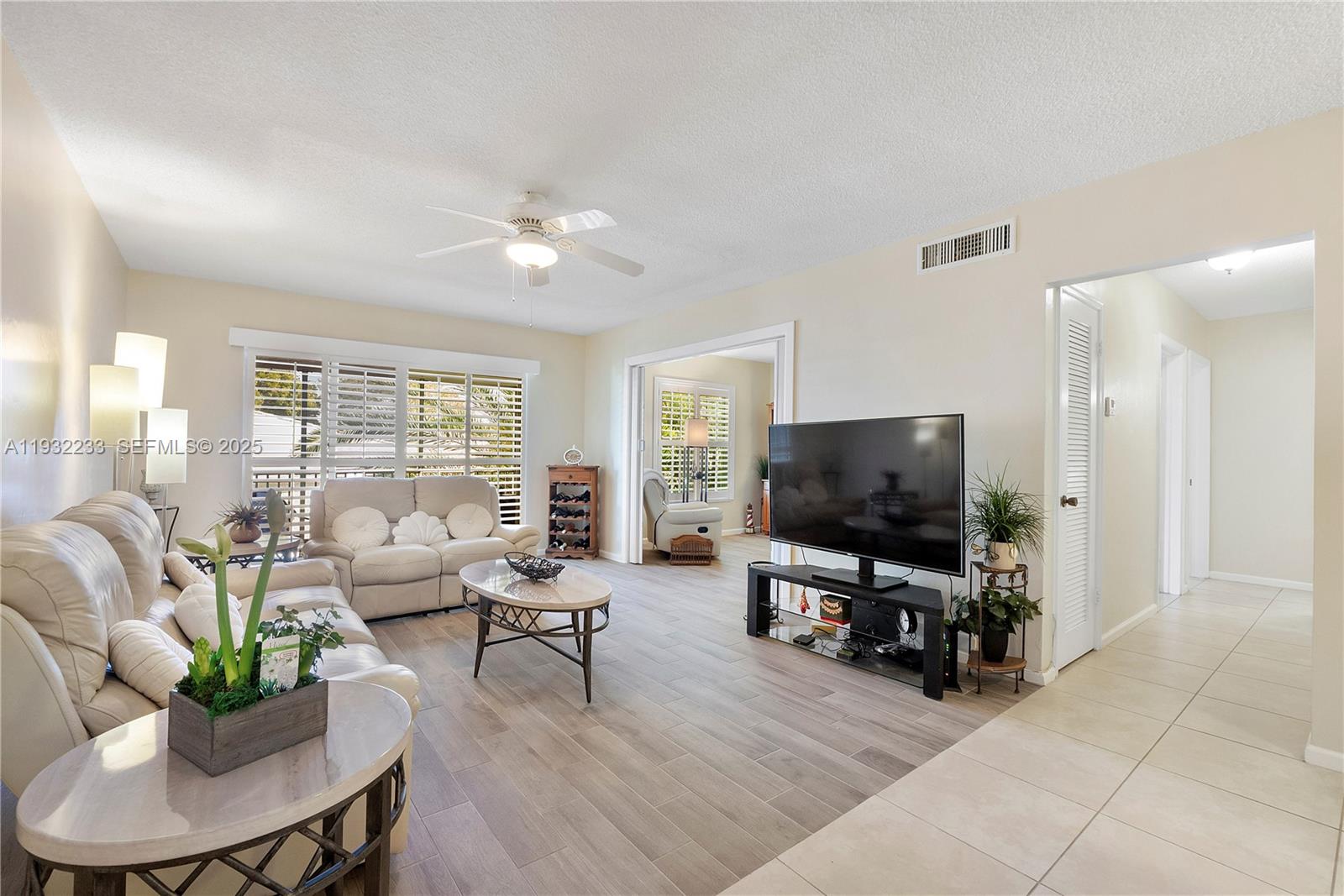 6750 Northeast 21st Road, Unit 124 Fort Lauderdale, FL 33308 - Photo 2 of 50 a living room with furniture and a flat screen tv