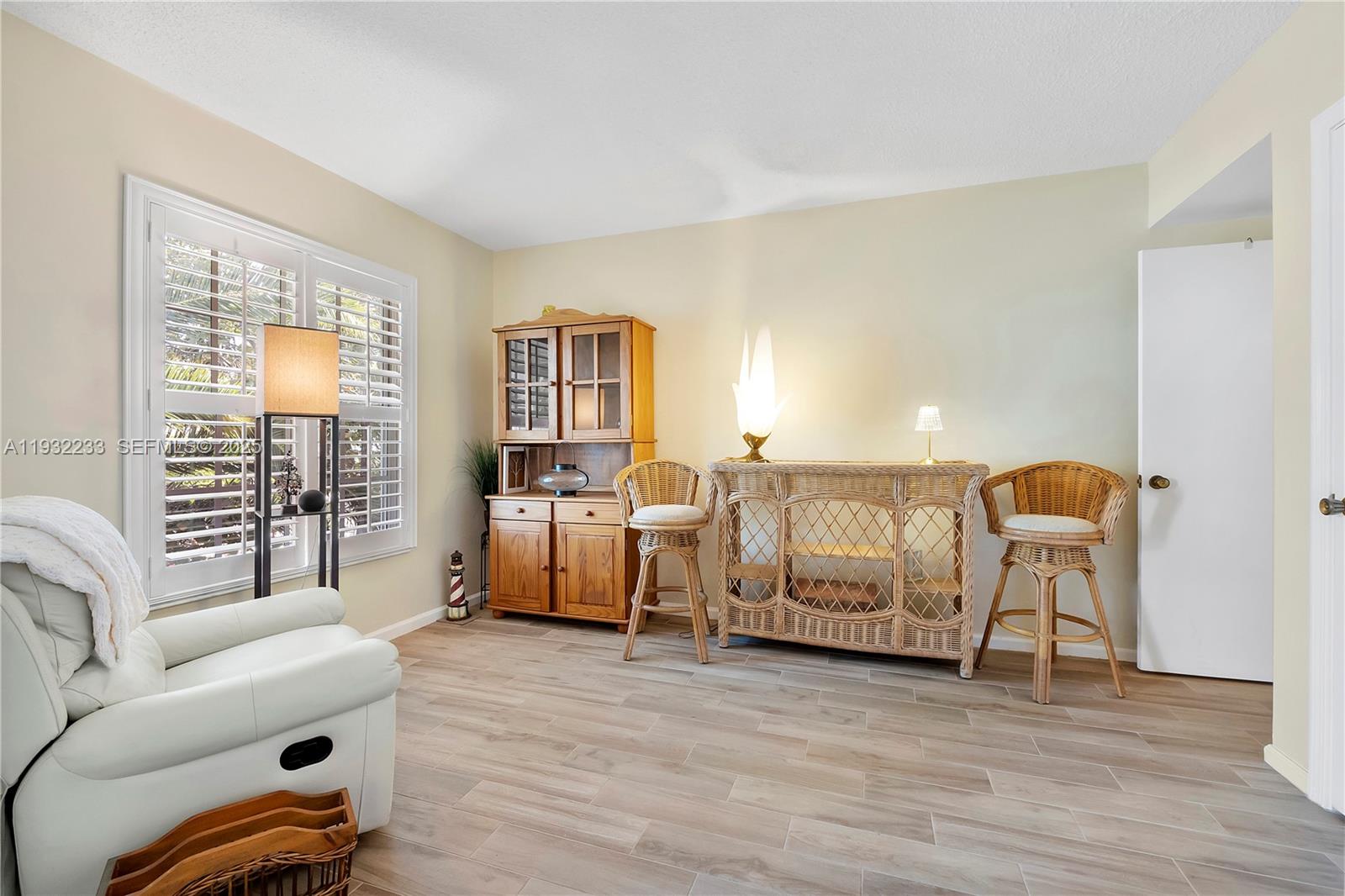 6750 Northeast 21st Road, Unit 124 Fort Lauderdale, FL 33308 - Photo 28 of 50 a living room with furniture and a table with wooden floor