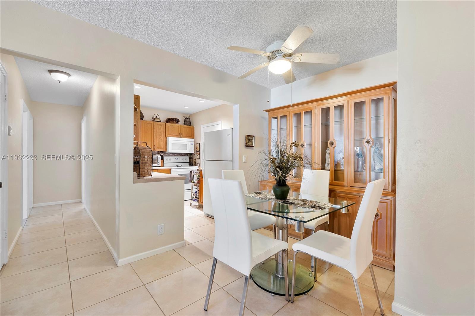 6750 Northeast 21st Road, Unit 124 Fort Lauderdale, FL 33308 - Photo 3 of 50 a view of a livingroom with furniture and a floor to ceiling window