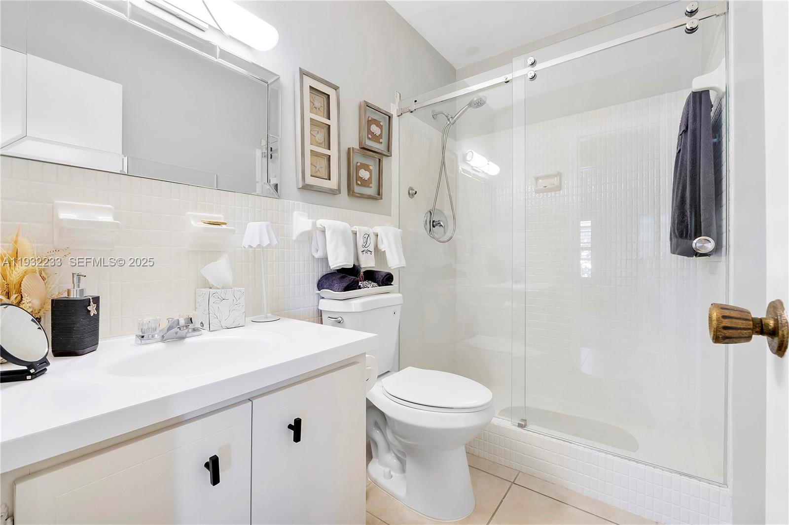 6750 Northeast 21st Road, Unit 124 Fort Lauderdale, FL 33308 - Photo 31 of 50 a bathroom with a sink a toilet and shower