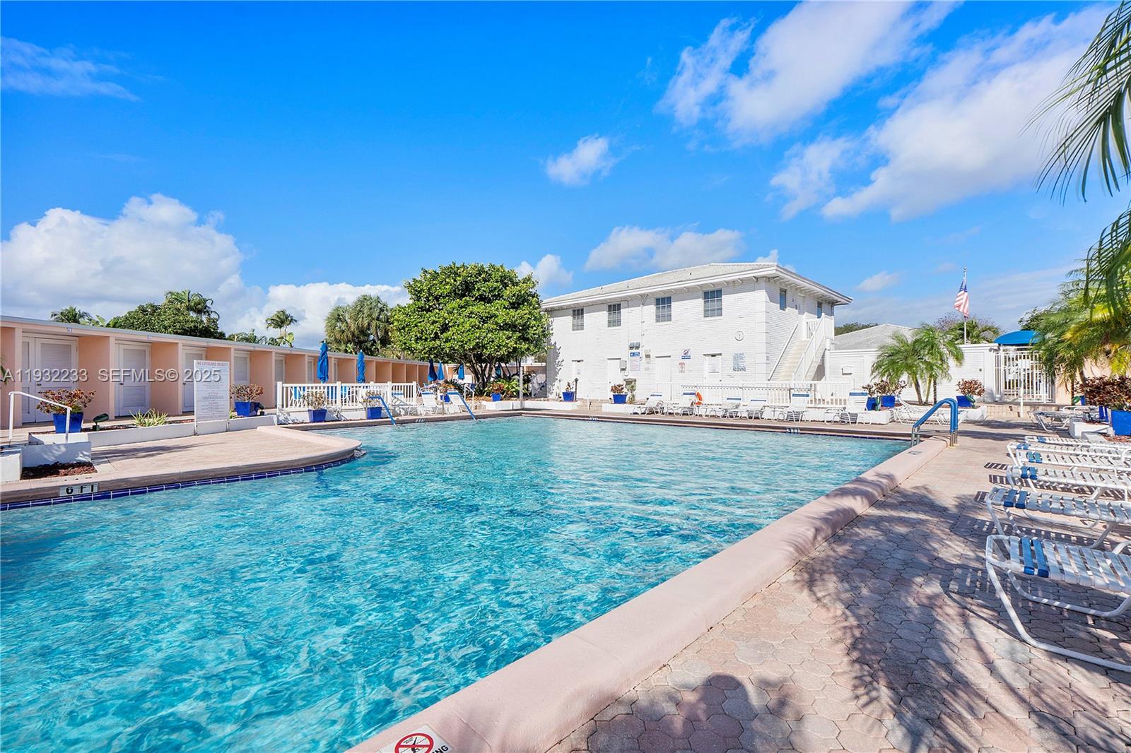 6750 Northeast 21st Road, Unit 124 Fort Lauderdale, FL 33308 - Photo 35 of 50 a view of a house with swimming pool lawn chairs and a fire pit
