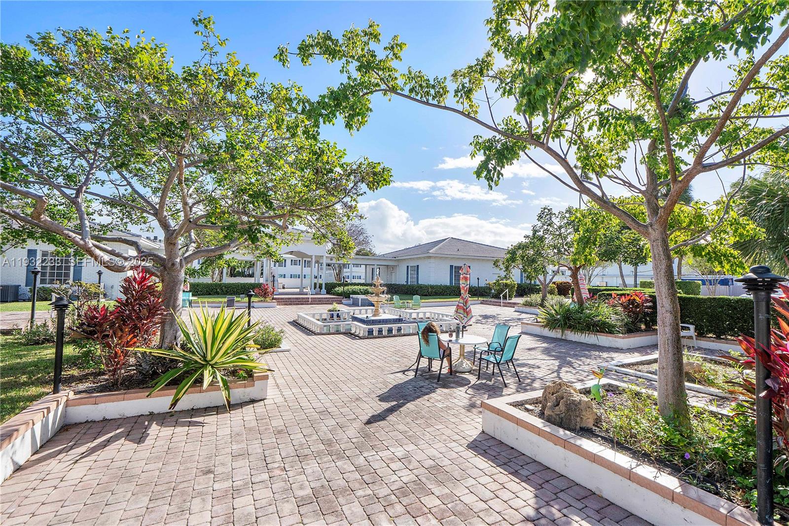 6750 Northeast 21st Road, Unit 124 Fort Lauderdale, FL 33308 - Photo 37 of 50 a view of a patio with table and chairs under an umbrella