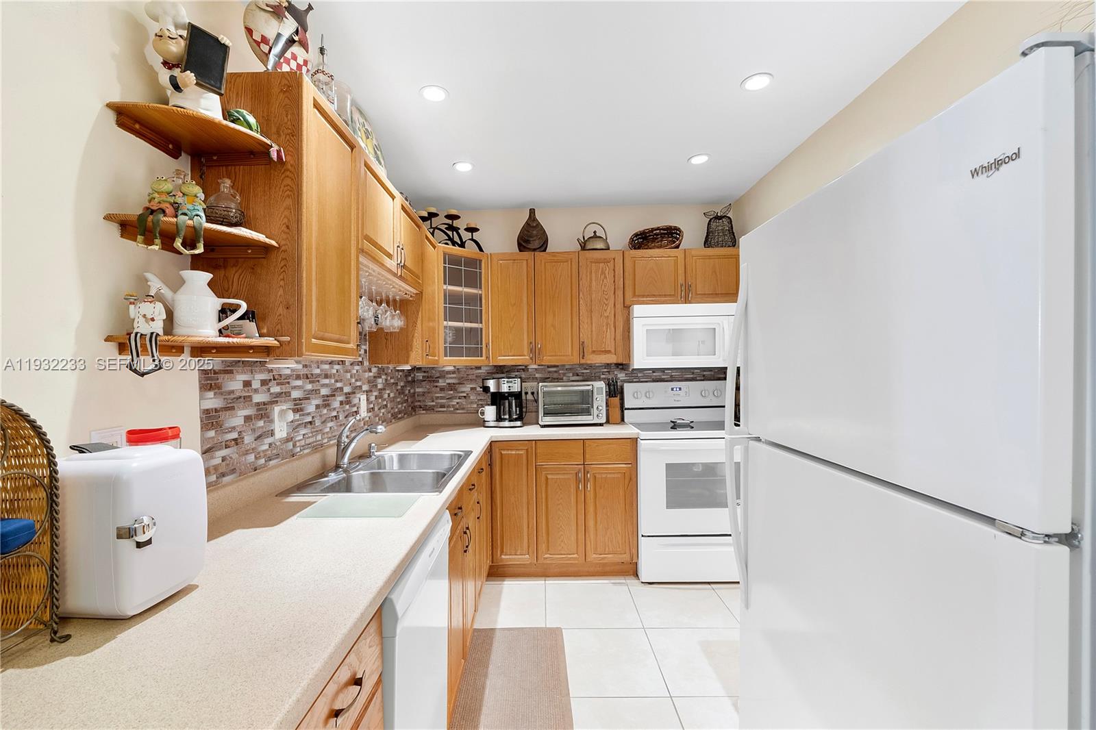6750 Northeast 21st Road, Unit 124 Fort Lauderdale, FL 33308 - Photo 4 of 50 a kitchen with a sink appliances and cabinets