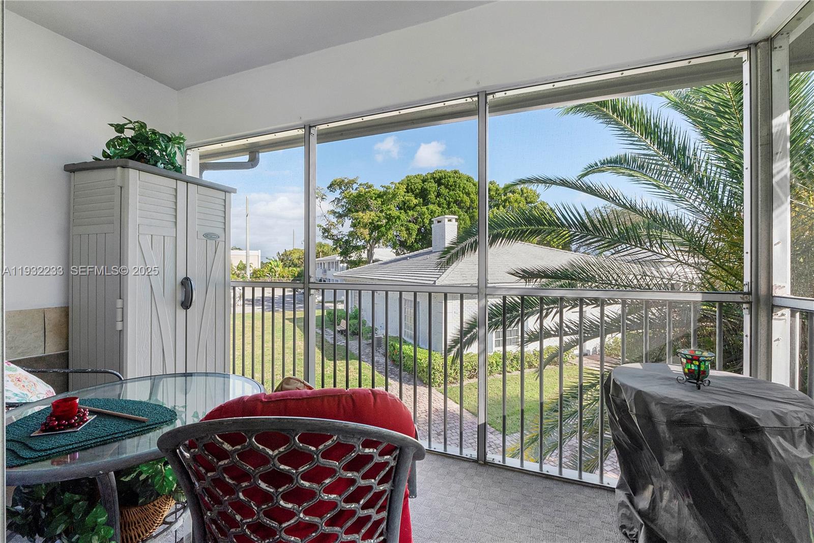 6750 Northeast 21st Road, Unit 124 Fort Lauderdale, FL 33308 - Photo 5 of 50 a balcony with furniture and garden view