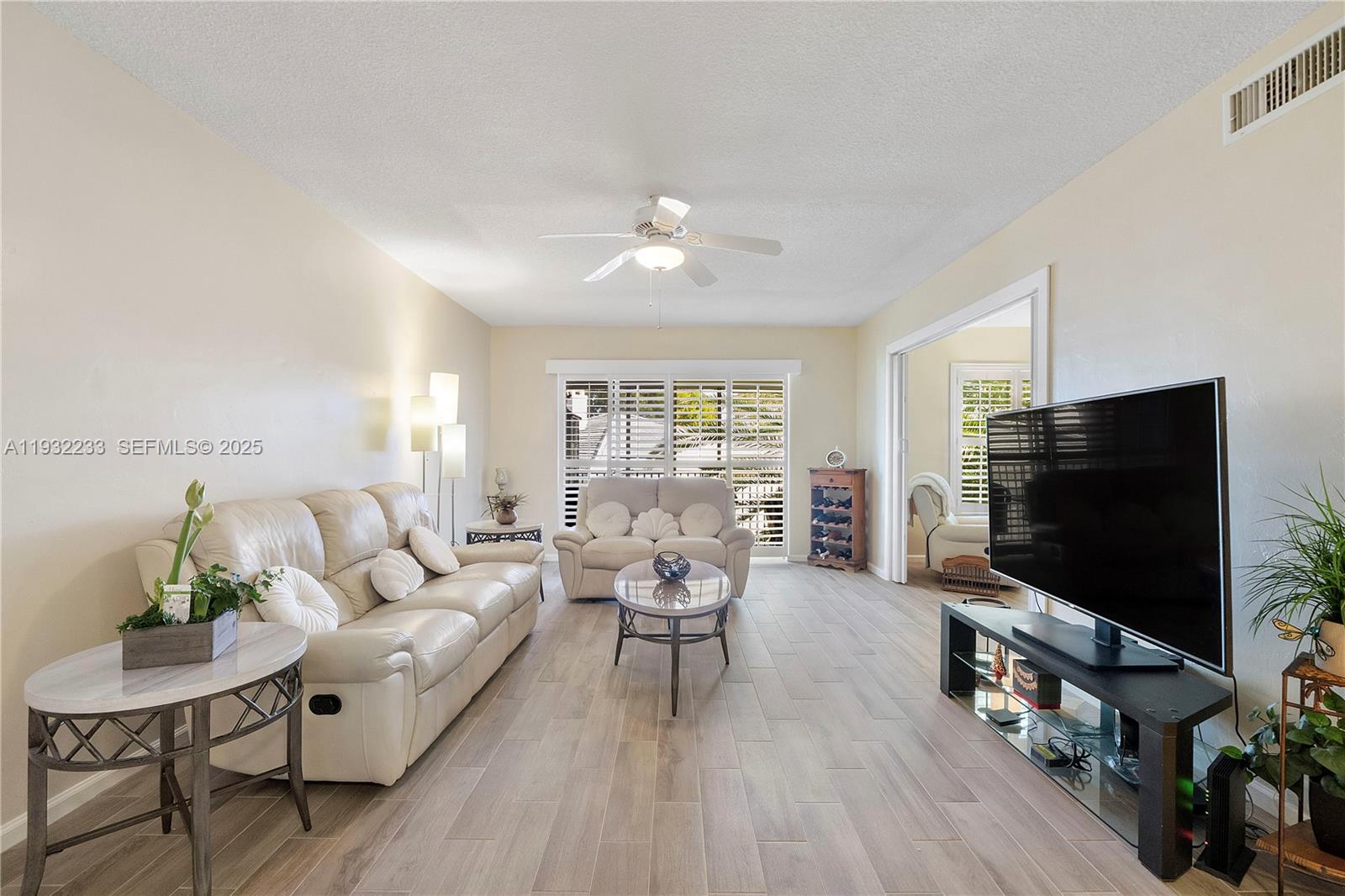 6750 Northeast 21st Road, Unit 124 Fort Lauderdale, FL 33308 - Photo 9 of 50 a living room with furniture and a flat screen tv