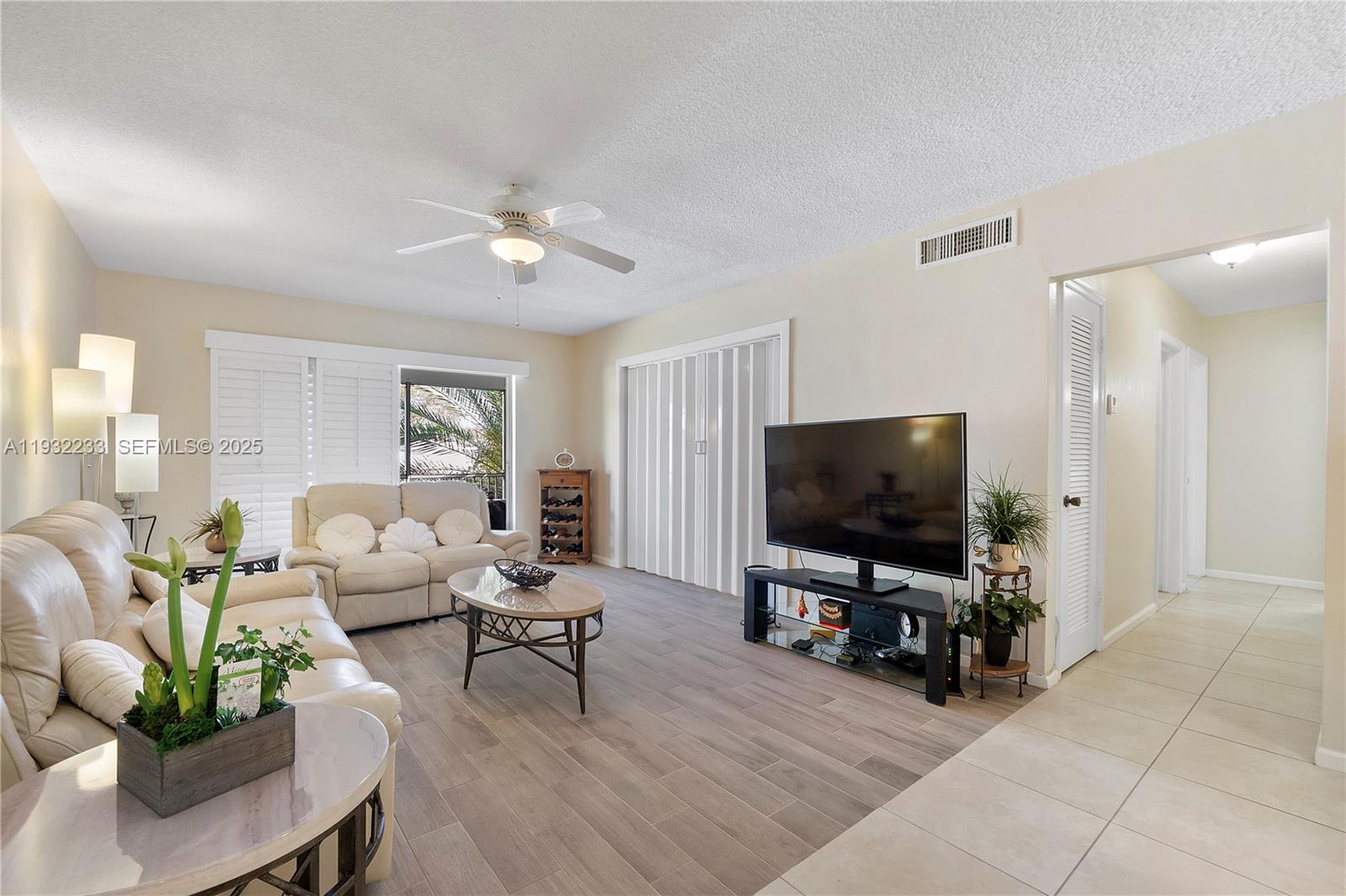 6750 Northeast 21st Road, Unit 124 Fort Lauderdale, FL 33308 - Photo 10 of 50 a living room with furniture and a flat screen tv