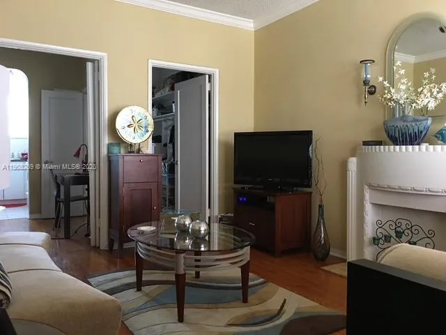 a living room with furniture a flat screen tv and a table