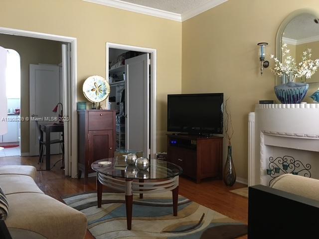 750 Euclid Avenue, Unit 8 Miami Beach, FL 33139 - Photo 4 of 8 a living room with furniture a flat screen tv and a table