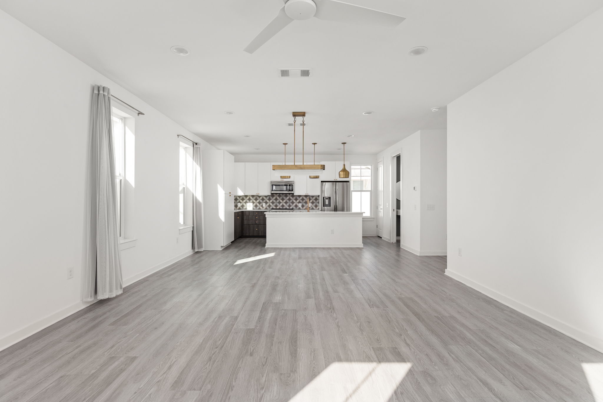 2624 Metcalfe Road, Unit 17 Austin, TX 78741 - Photo 14 of 35 a large kitchen with a wooden floor and stainless steel appliances