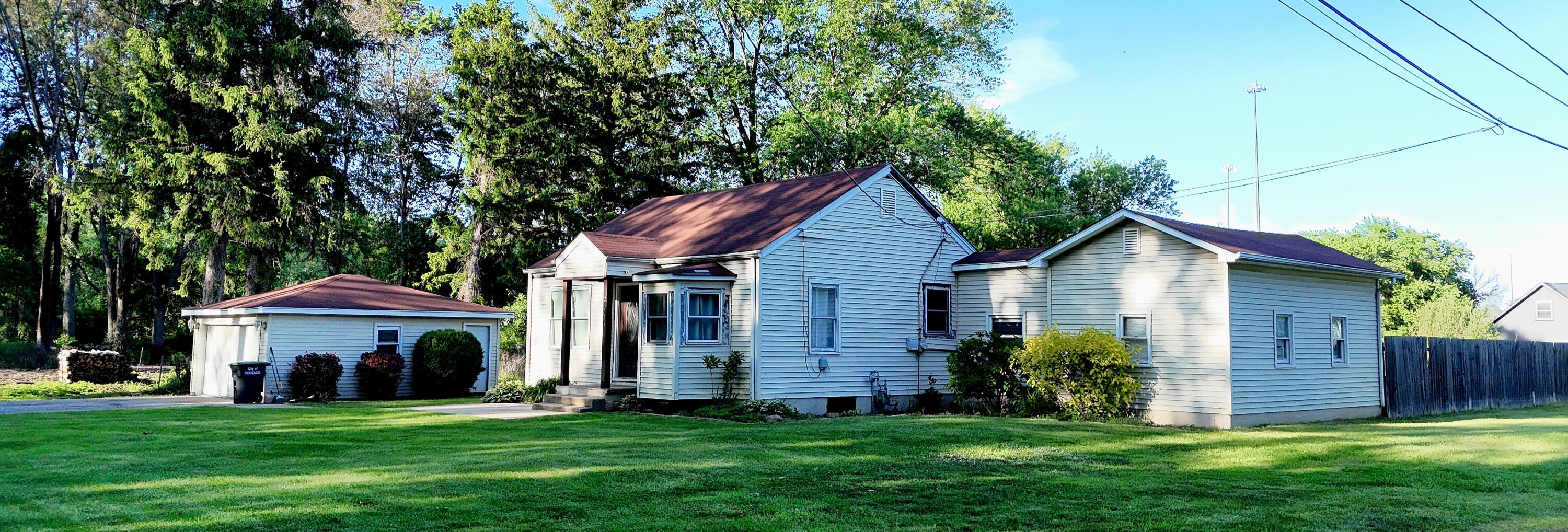 2207 North County Line Road Portage, IN 46368 - Photo 6 of 16 a view of a yard in front of a house with plants and large tree