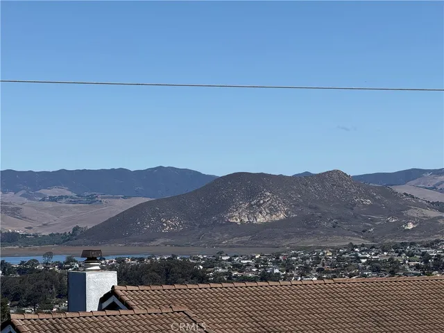 an aerial view of residential house and mountains in the background