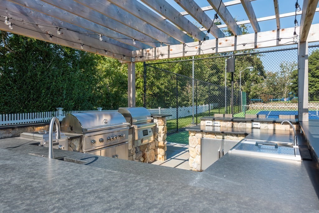 652 Route 28 Harwich, MA 02646 - Photo 12 of 24 a view of a patio with a table chairs and a backyard