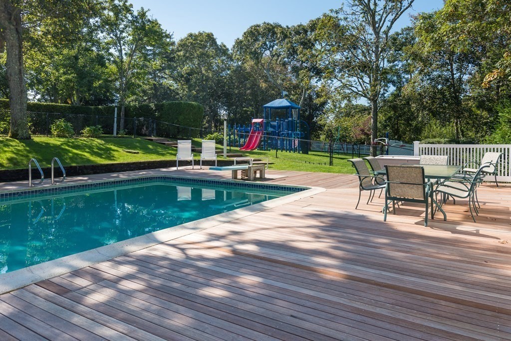 652 Route 28 Harwich, MA 02646 - Photo 15 of 24 a view of a swimming pool with a patio and a yard