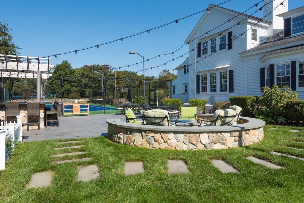 652 Route 28 Harwich, MA 02646 - Photo 16 of 24 a view of a house with swimming pool lawn chairs and a yard