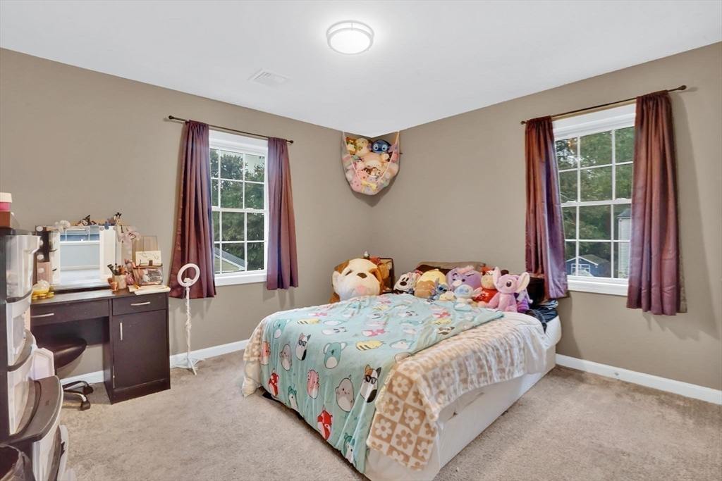 28 Juliet Street Springfield, MA 01118 - Photo 22 of 42 a bedroom with a bed and a table in it