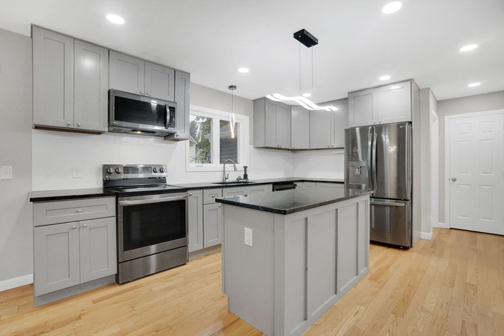28 Juliet Street Springfield, MA 01118 - Photo 9 of 42 a kitchen with stainless steel appliances granite countertop a refrigerator stove a sink and a microwave