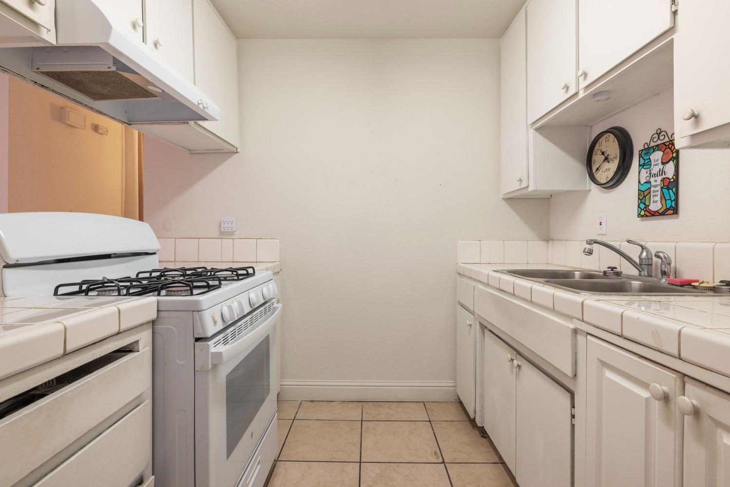 2644 San Ignacio Avenue Modesto, CA 95354 - Photo 11 of 32 a kitchen with a stove and a sink