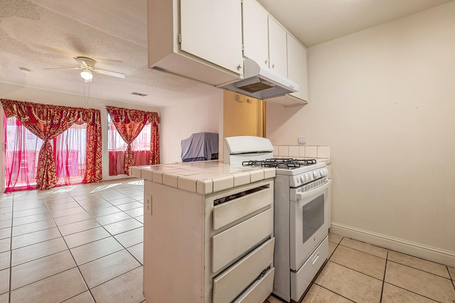 2644 San Ignacio Avenue Modesto, CA 95354 - Photo 12 of 32 a kitchen with a stove and a microwave
