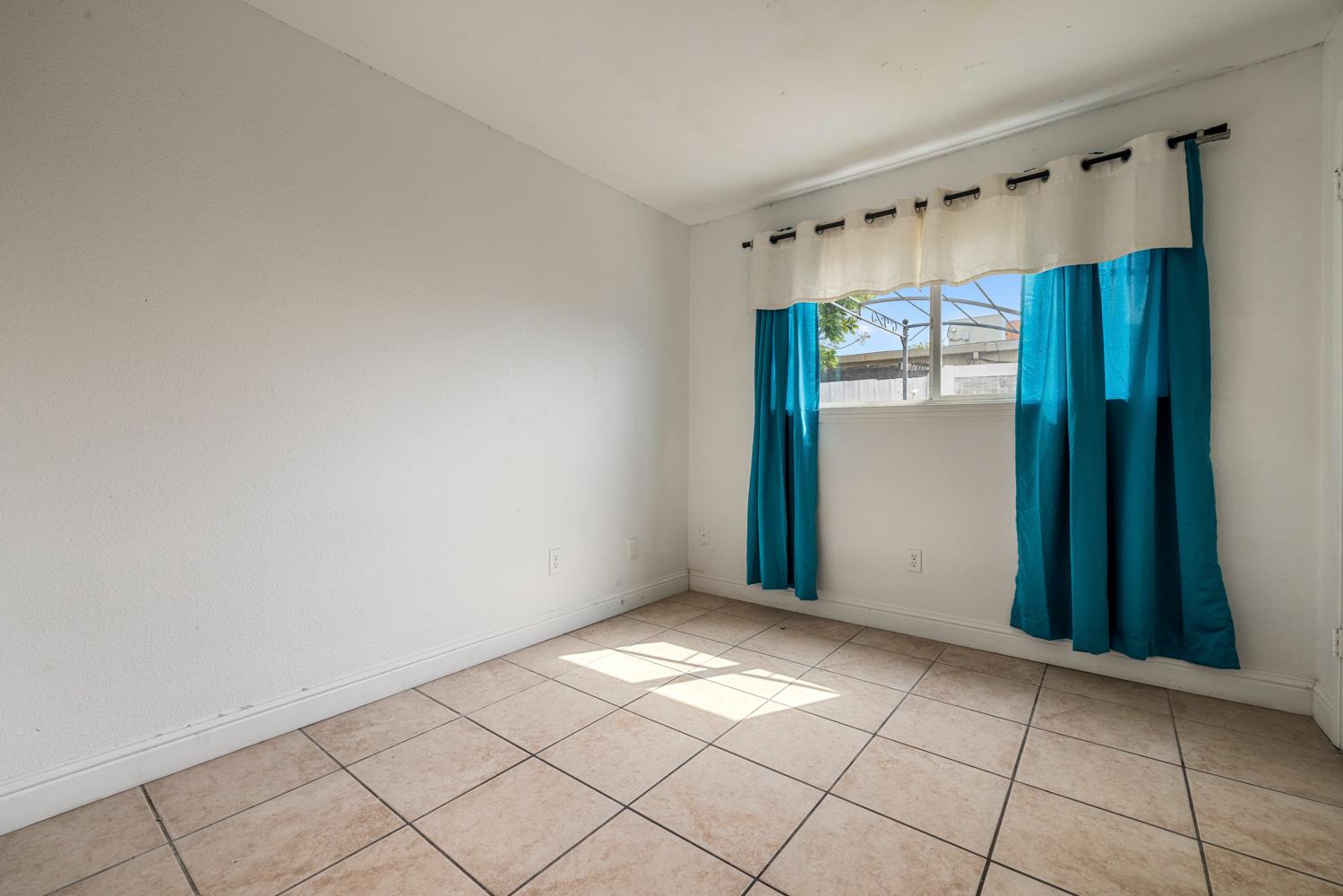2644 San Ignacio Avenue Modesto, CA 95354 - Photo 16 of 32 a view of an empty room with window and cabinet