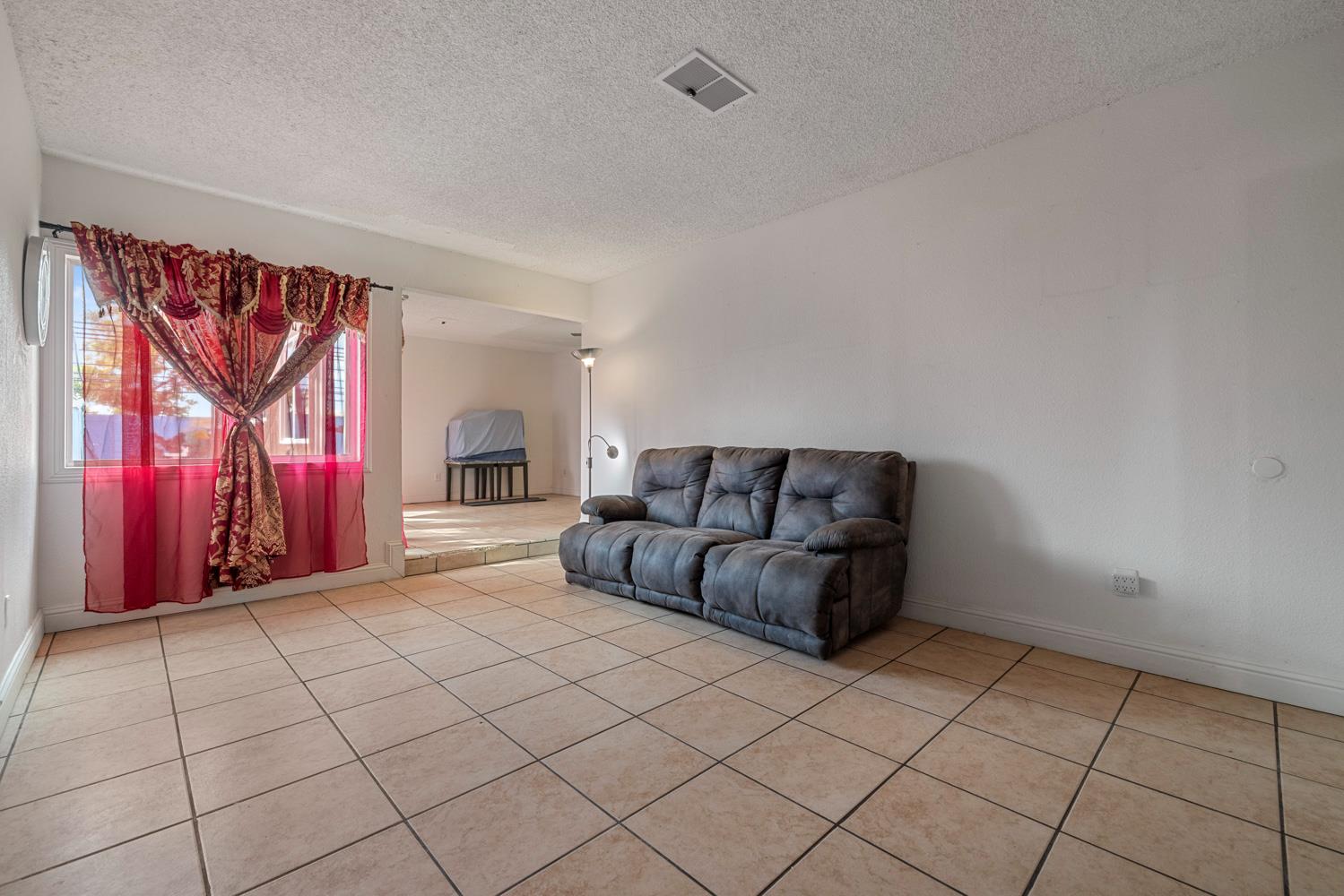 2644 San Ignacio Avenue Modesto, CA 95354 - Photo 5 of 32 a living room with furniture and a fireplace