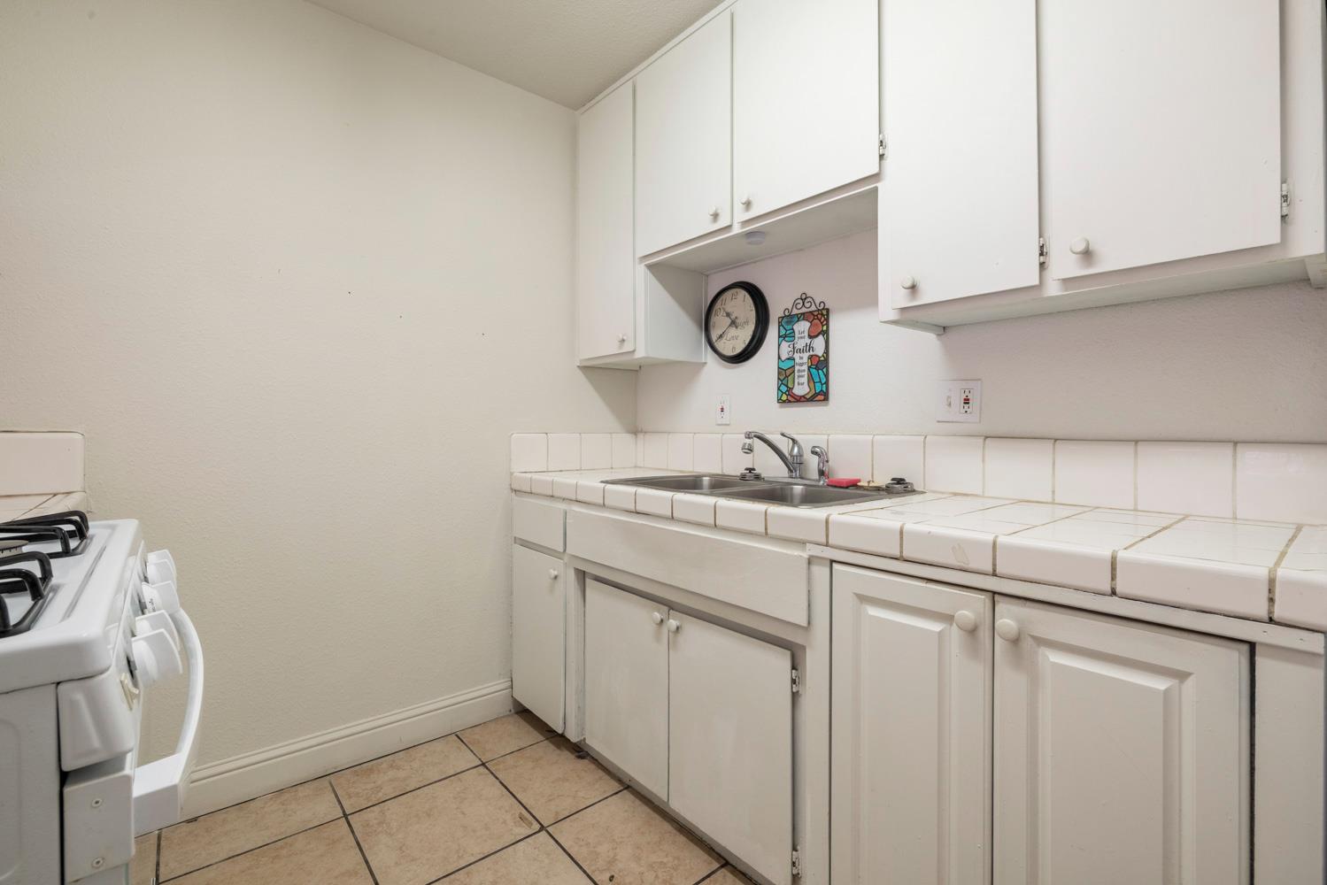 2644 San Ignacio Avenue Modesto, CA 95354 - Photo 10 of 32 a kitchen with a sink and cabinets