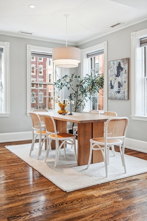 61 Revere Street, Unit 3 Boston, MA 02114 - Photo 3 of 15 a view of a dining room with furniture a chandelier and wooden floor