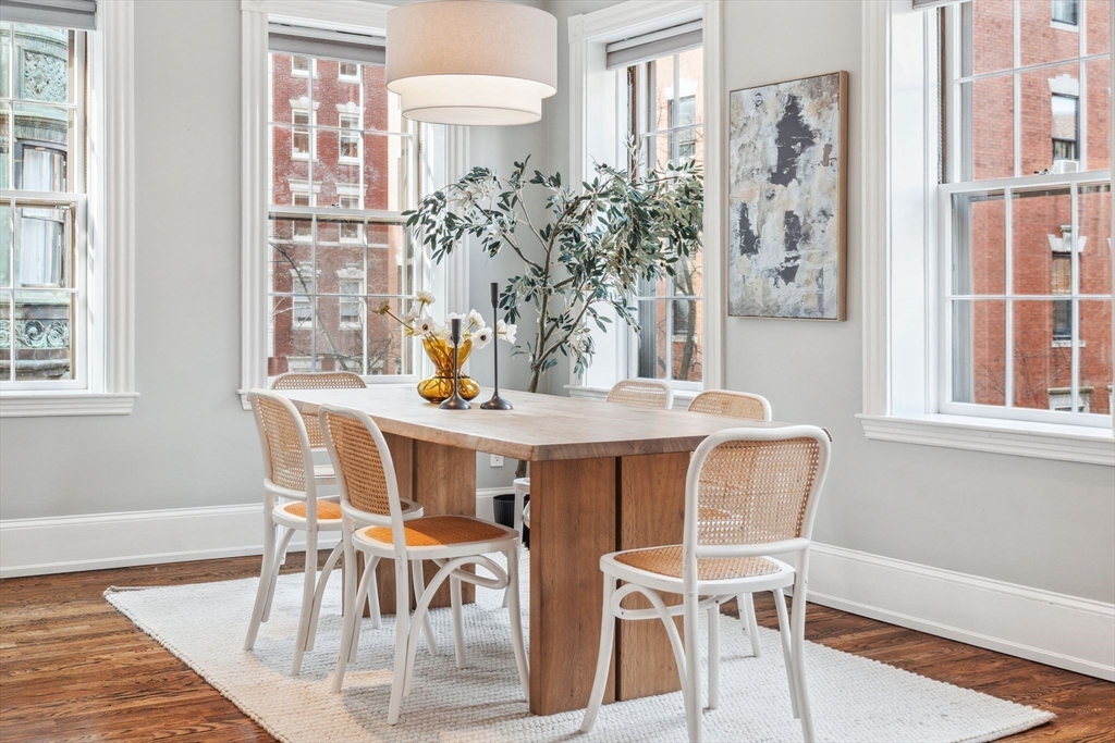 61 Revere Street, Unit 3 Boston, MA 02114 - Photo 4 of 15 a view of a dining room with furniture and wooden floor