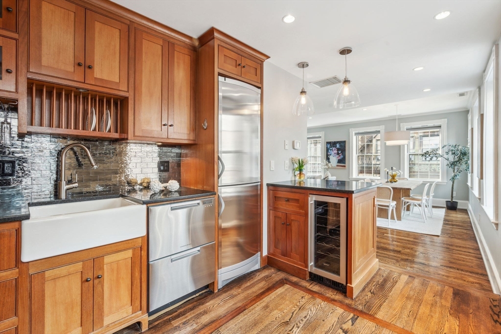 61 Revere Street, Unit 3 Boston, MA 02114 - Photo 7 of 15 a kitchen with stainless steel appliances granite countertop a refrigerator and a stove top oven