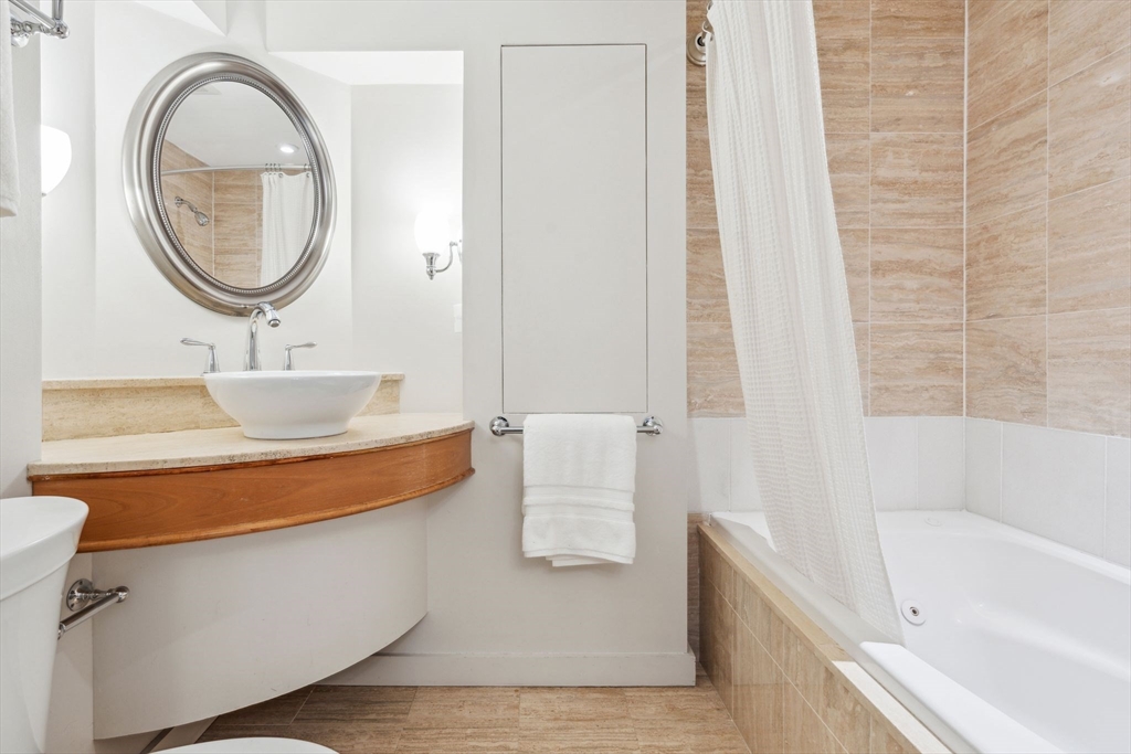 61 Revere Street, Unit 3 Boston, MA 02114 - Photo 10 of 15 a bathroom with a sink and a mirror