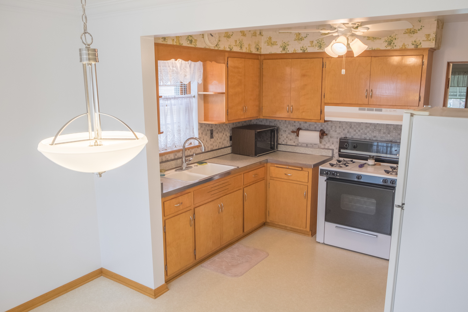 9016 West 23rd Street North Riverside, IL 60546 - Photo 15 of 49 a kitchen with a sink stove and cabinets