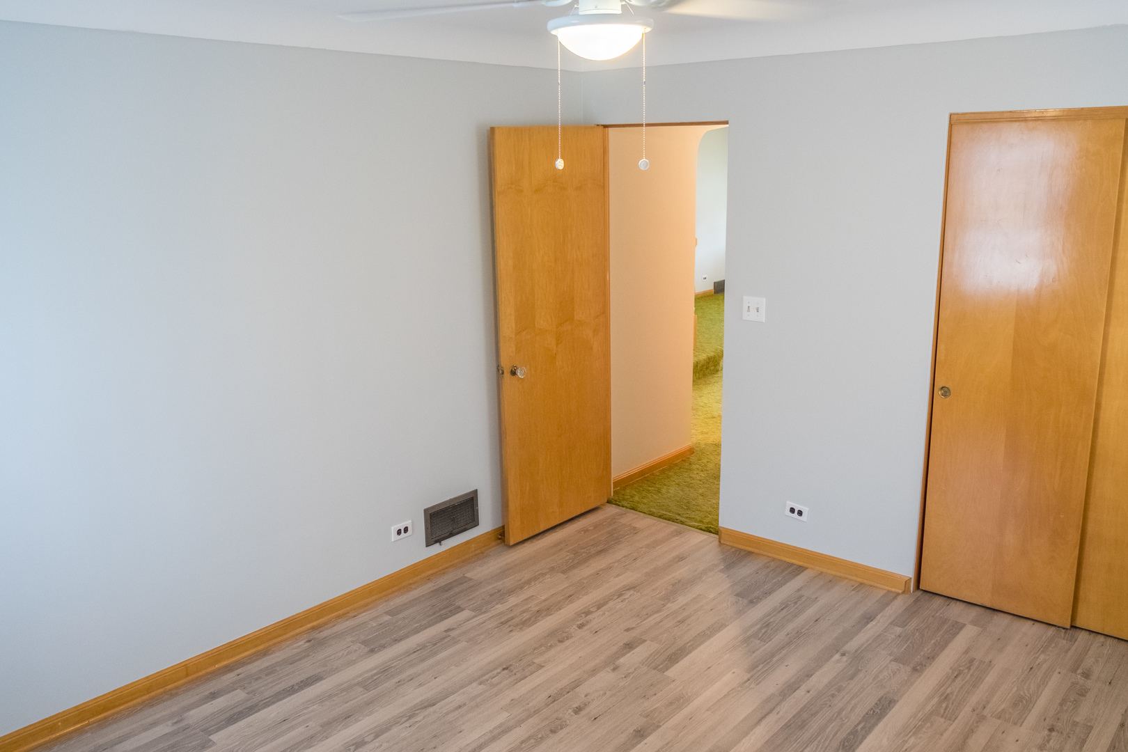 9016 West 23rd Street North Riverside, IL 60546 - Photo 19 of 49 an empty room with wooden floor and bathroom view