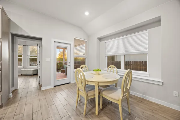 a dining room with furniture and wooden floor