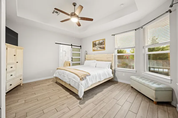 a bedroom with a large bed and a window