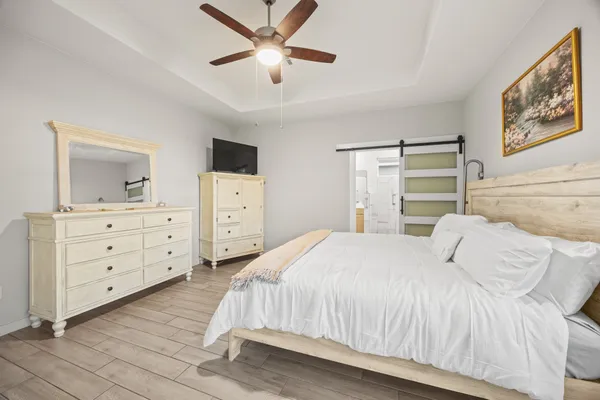 a bedroom with a large bed and a dresser
