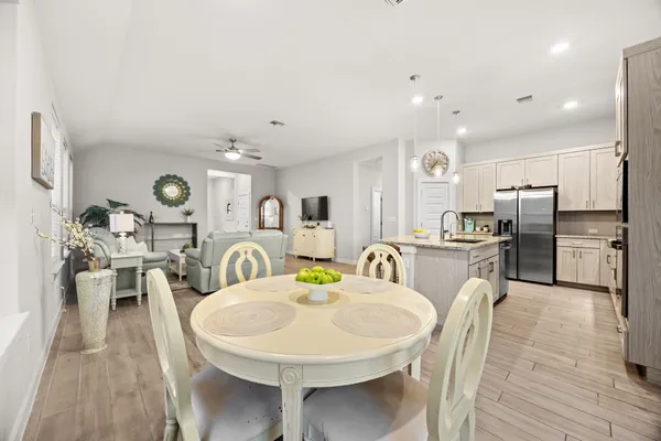 a large kitchen with a table and chairs