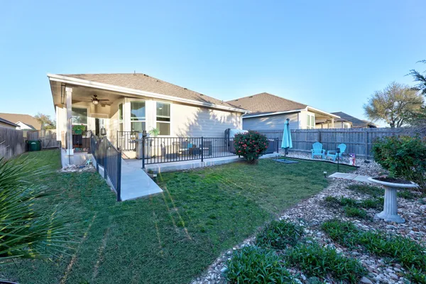 a front view of a house with a yard and outdoor seating