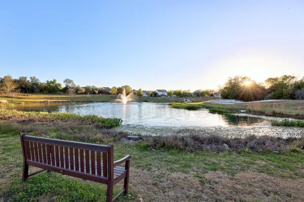 a view of a lake with houses in the back