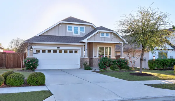 a front view of a house with garden