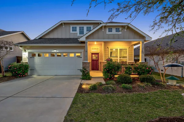 a front view of a house with garden