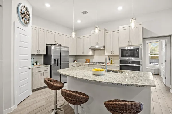 a kitchen with a refrigerator a stove a sink and a refrigerator