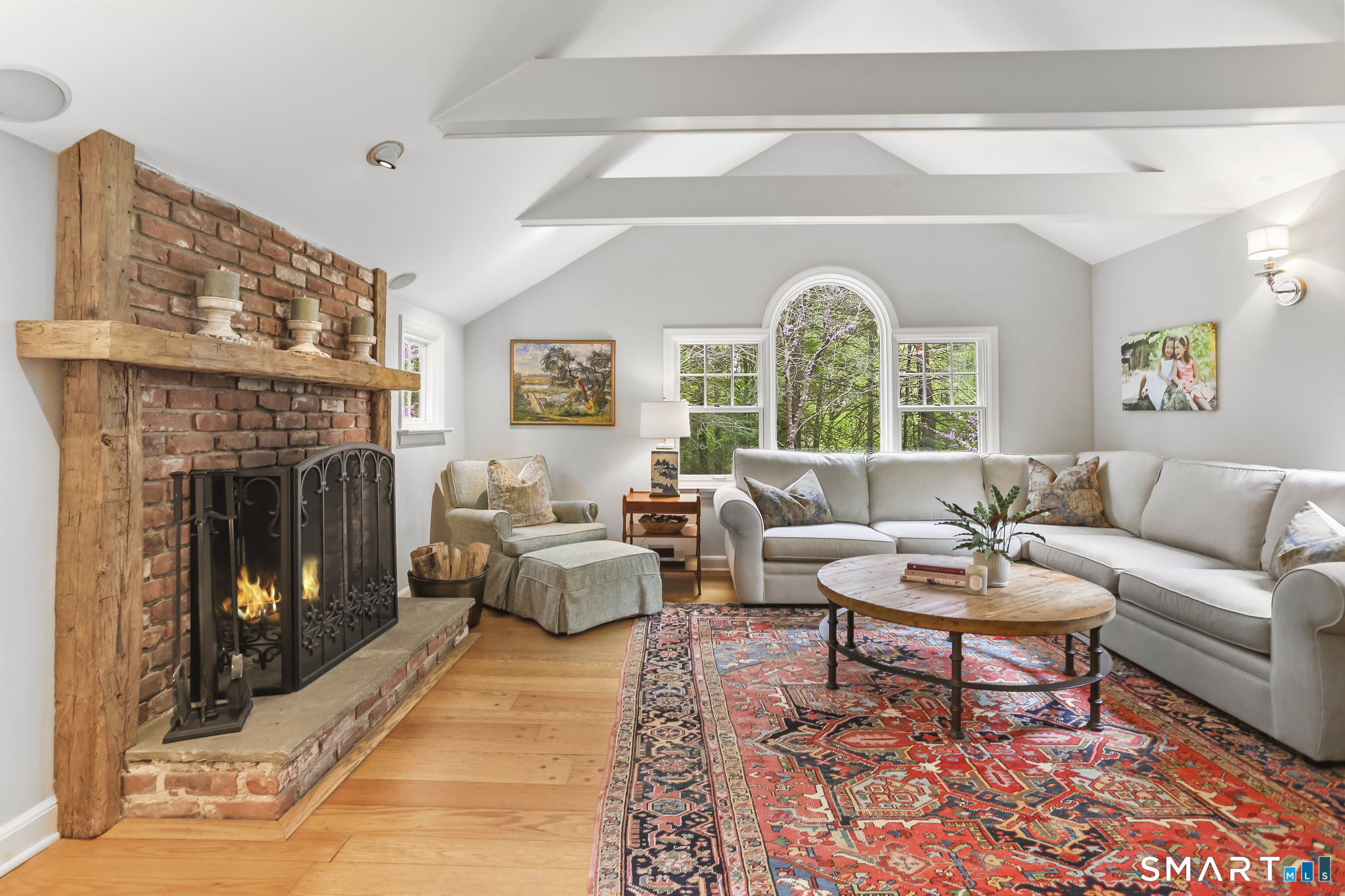 23 Old Stage Coach Road Weston, CT 06883 - Photo 13 of 37 a living room with furniture a fireplace and a large window