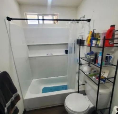 a bathroom with a sink toilet and shower