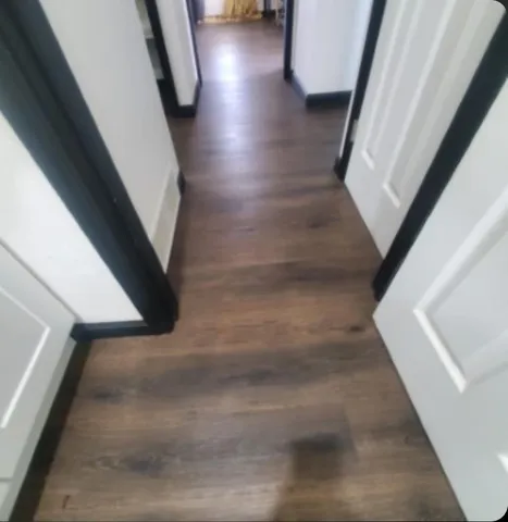 a living room with furniture a flat screen tv and a large window